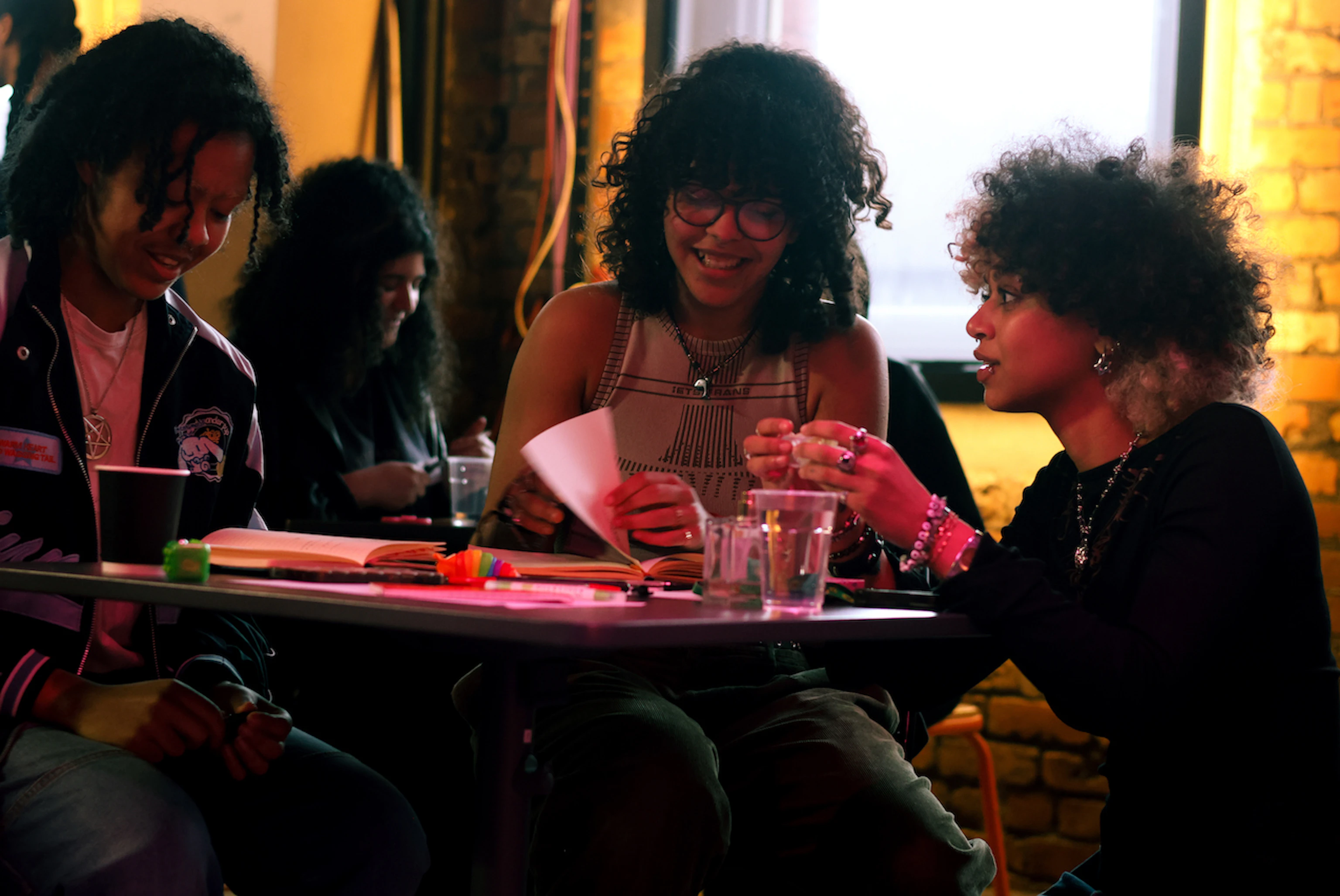 People sat at a table discussing and smiling.
