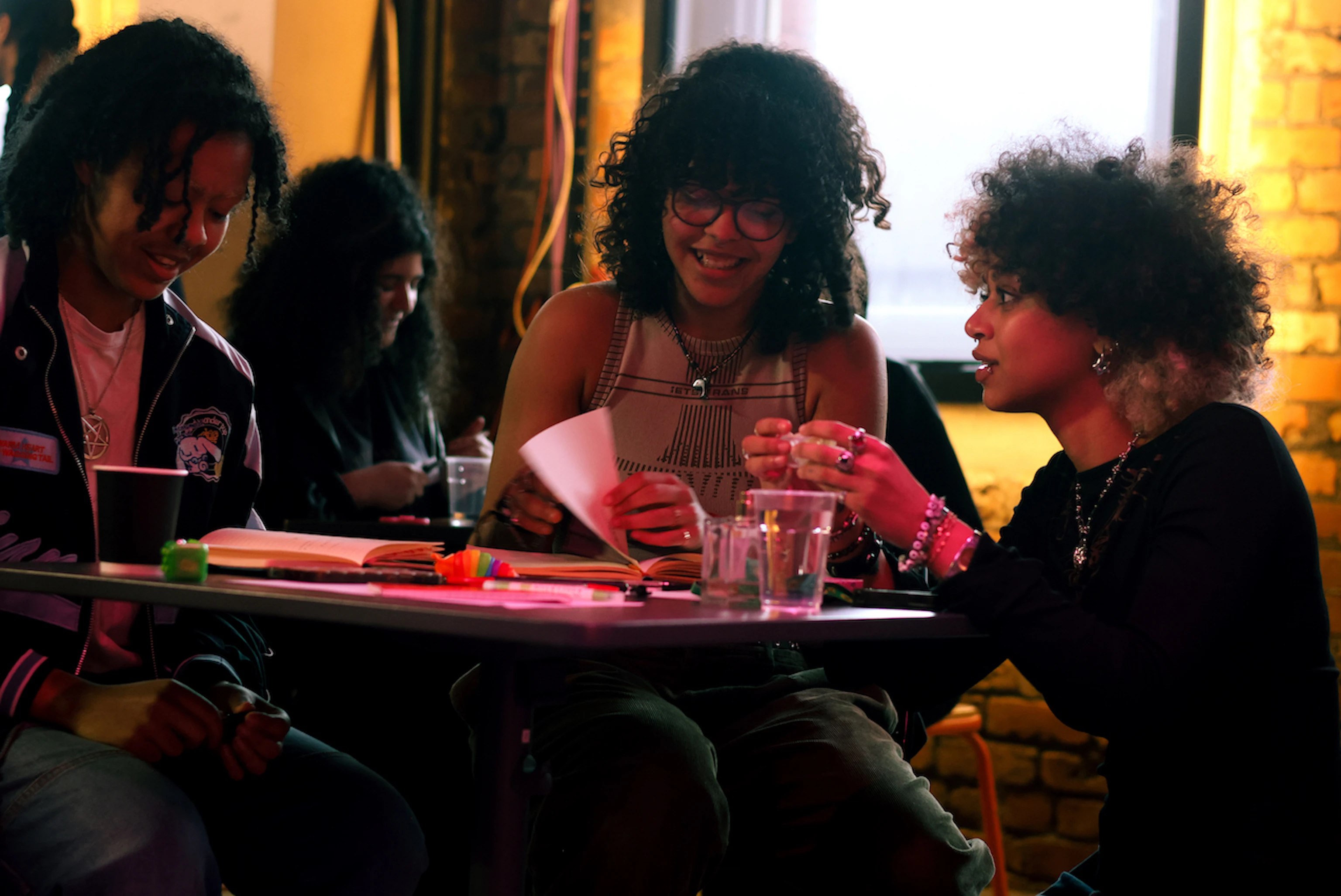 People sat at a table discussing and smiling.