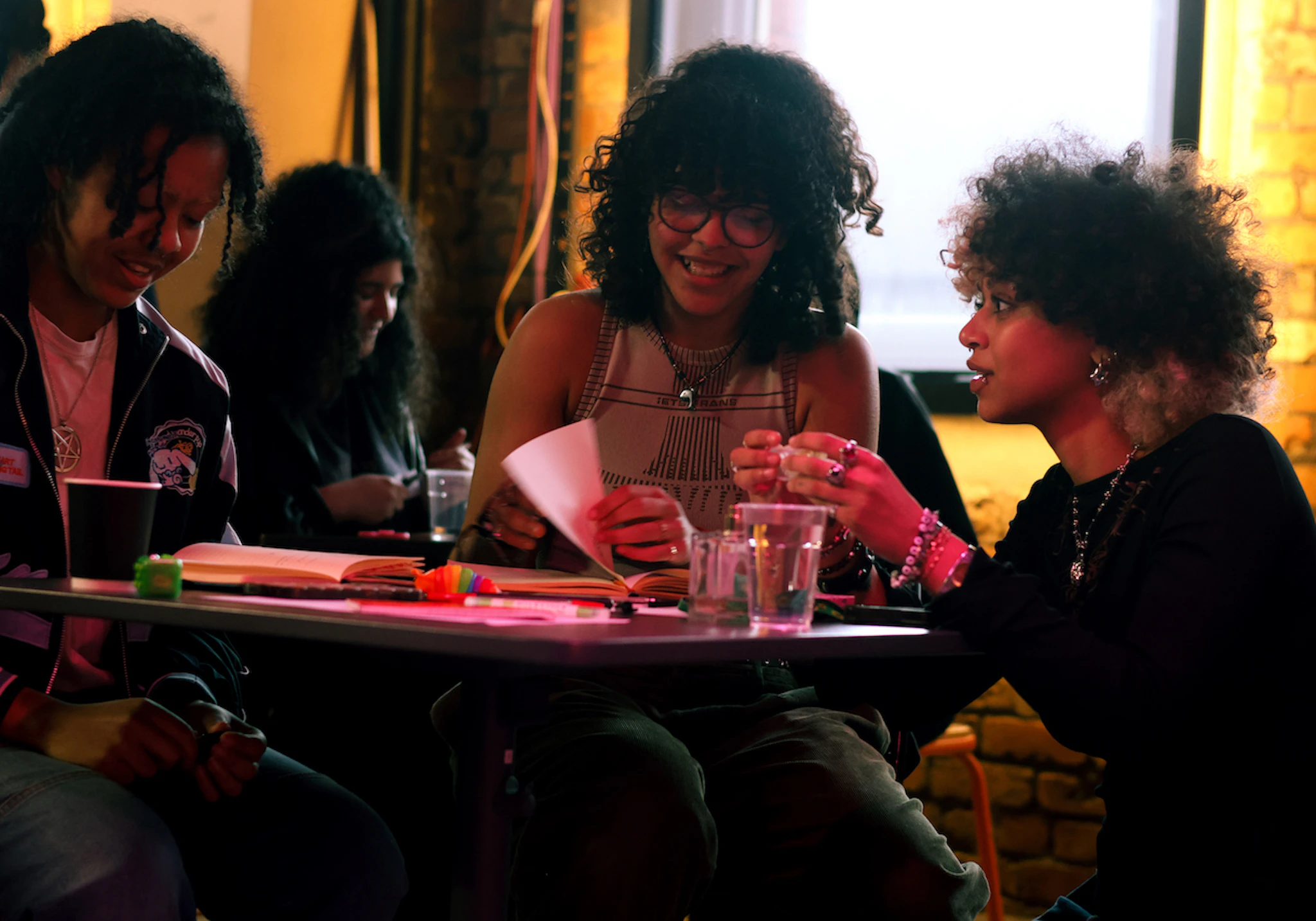 People sat at a table discussing and smiling.