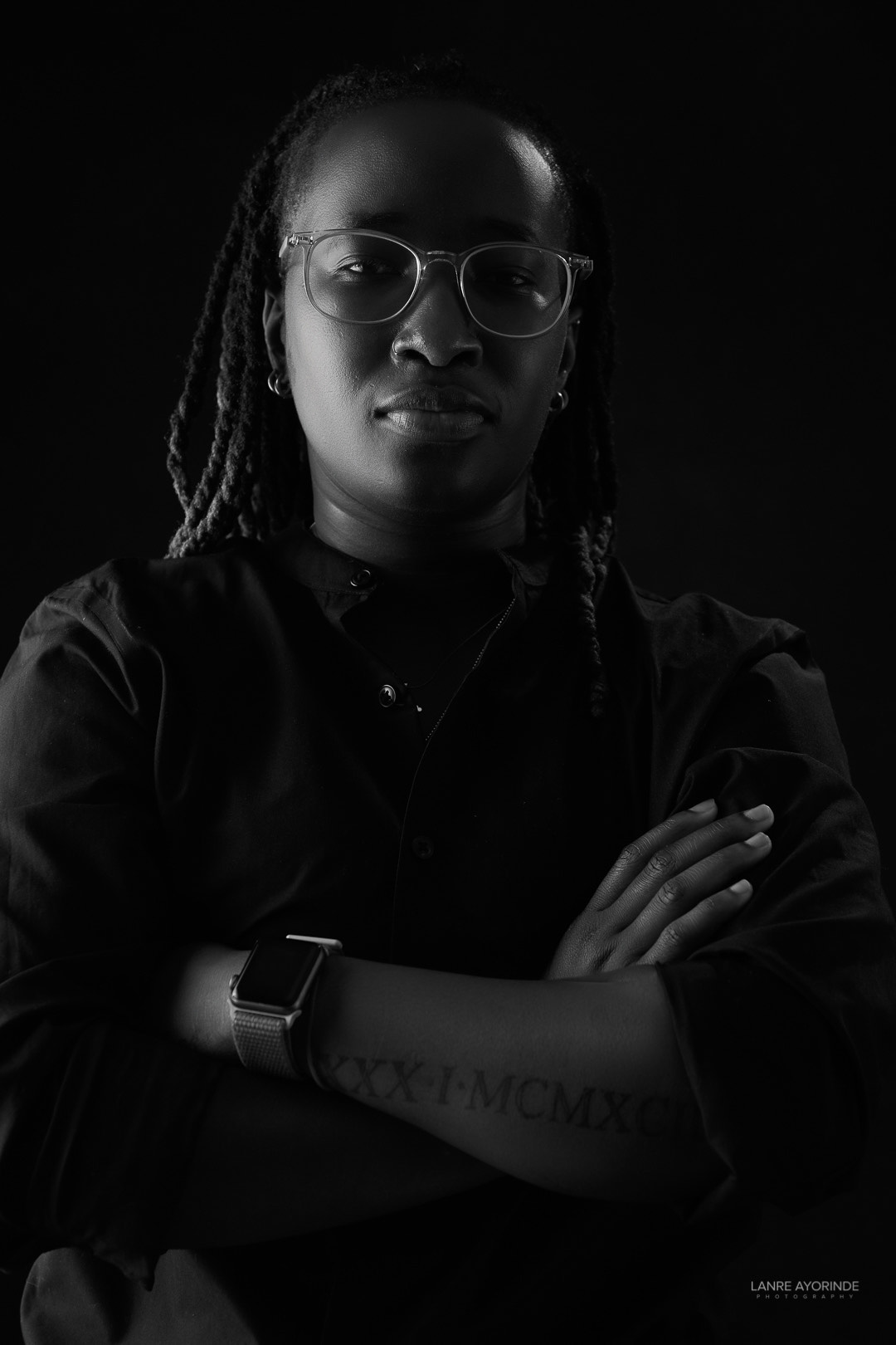 Omolola Oyedele looking to camera with her arms crossed.