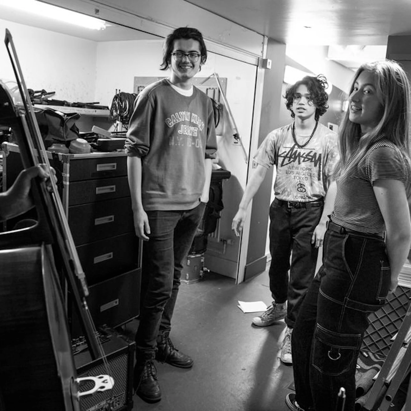 Tom and three other musicians backstage during a live event.