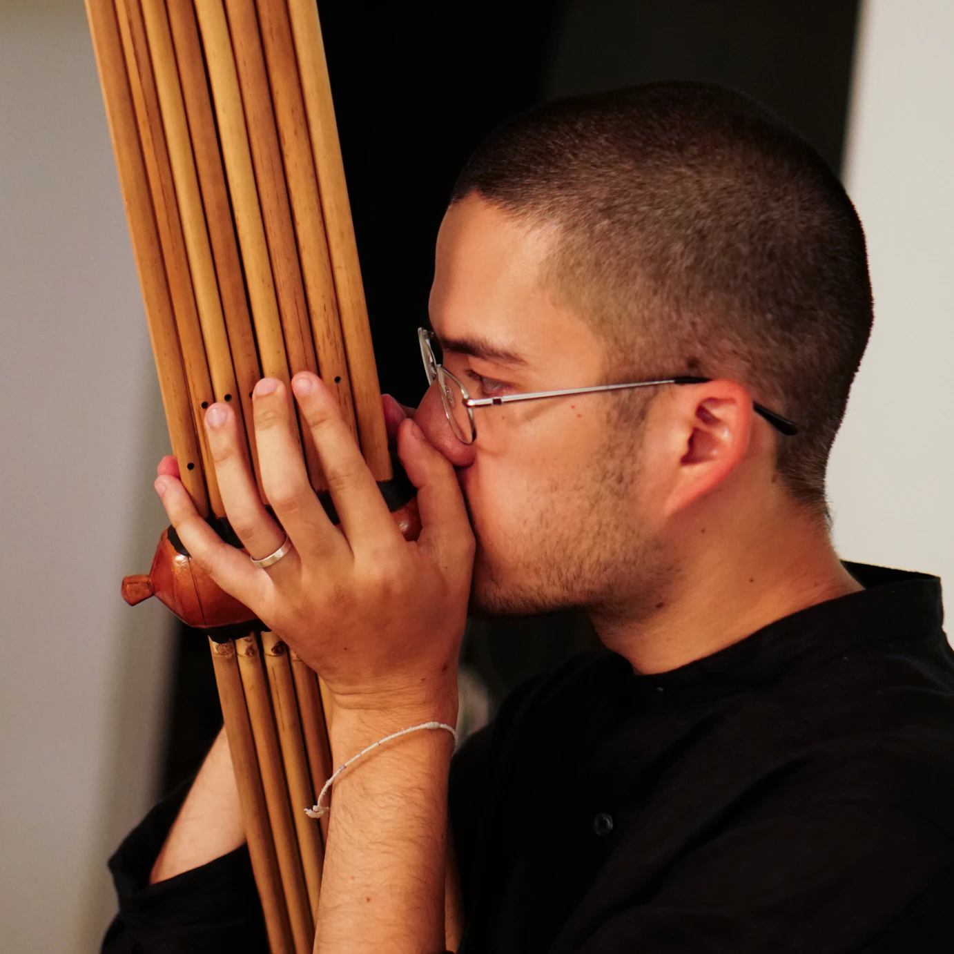 Kai playing the khaen in rehearsals.