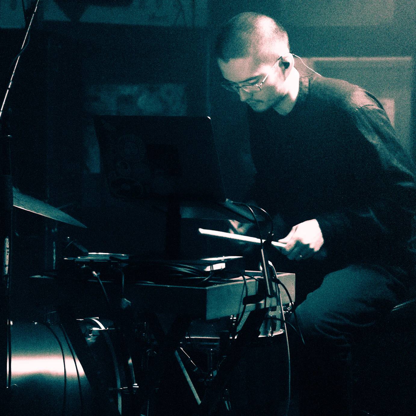 Kai drumming on stage.