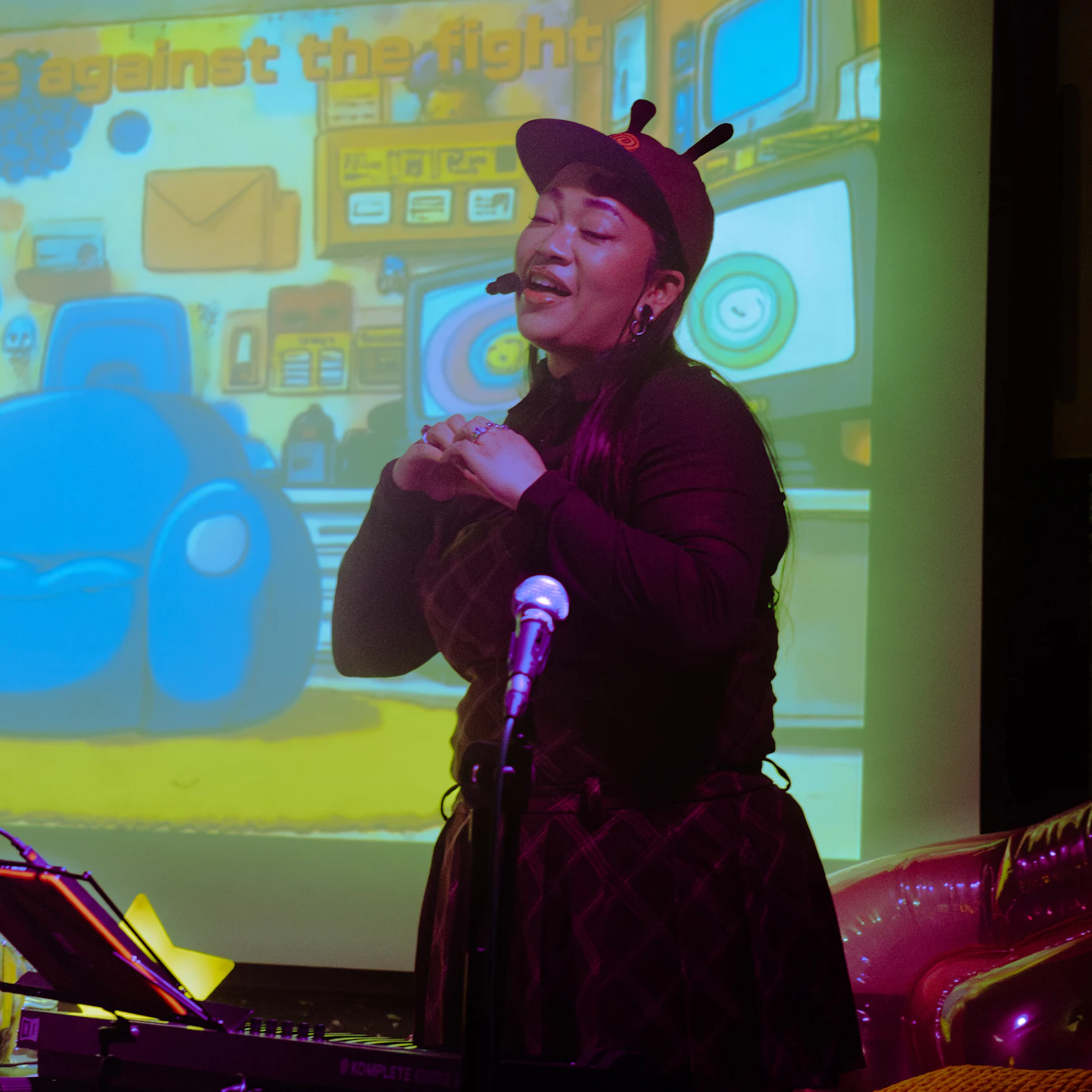 Kyami singing on stage.