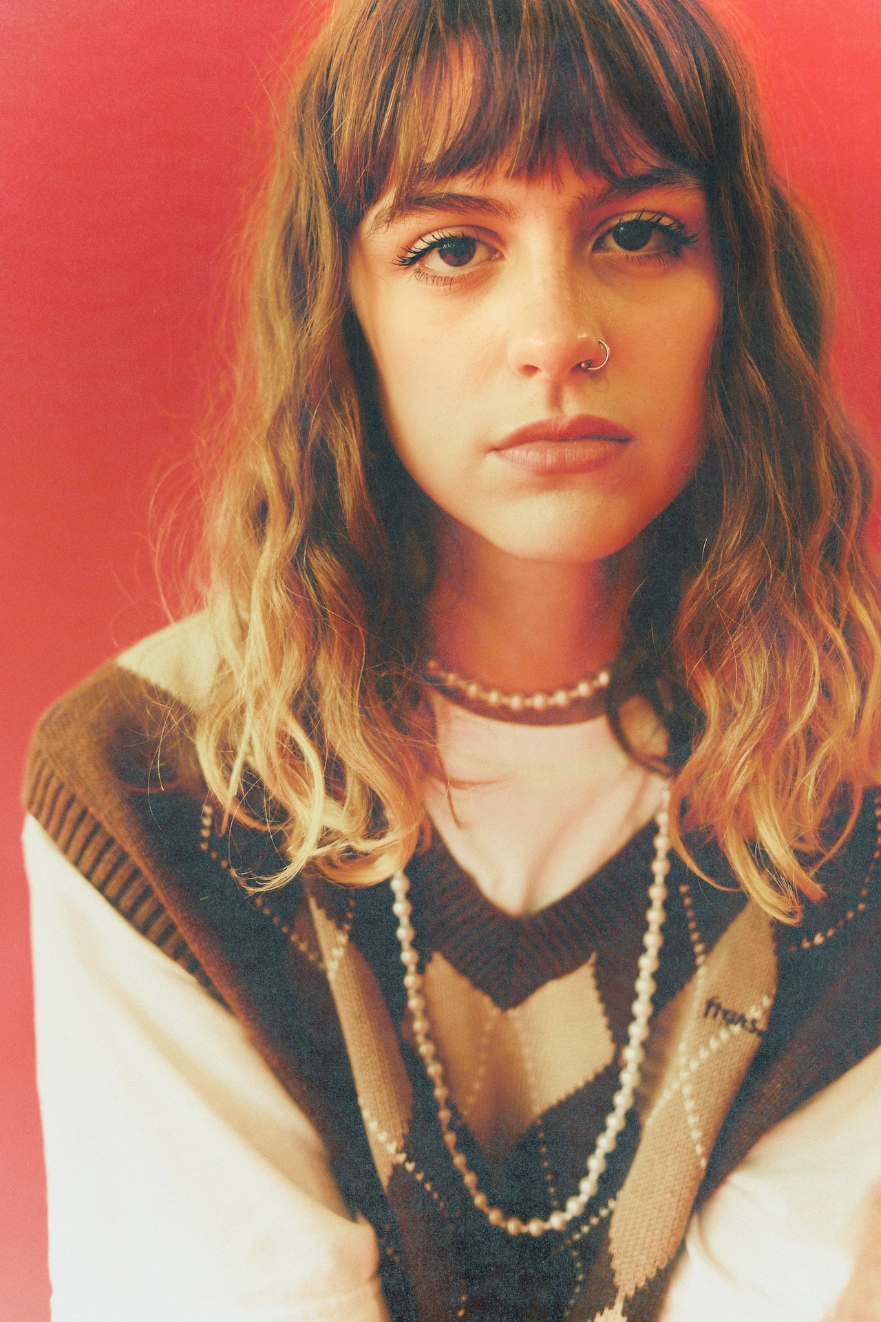 Press photo of Chloe Slater on a red background.