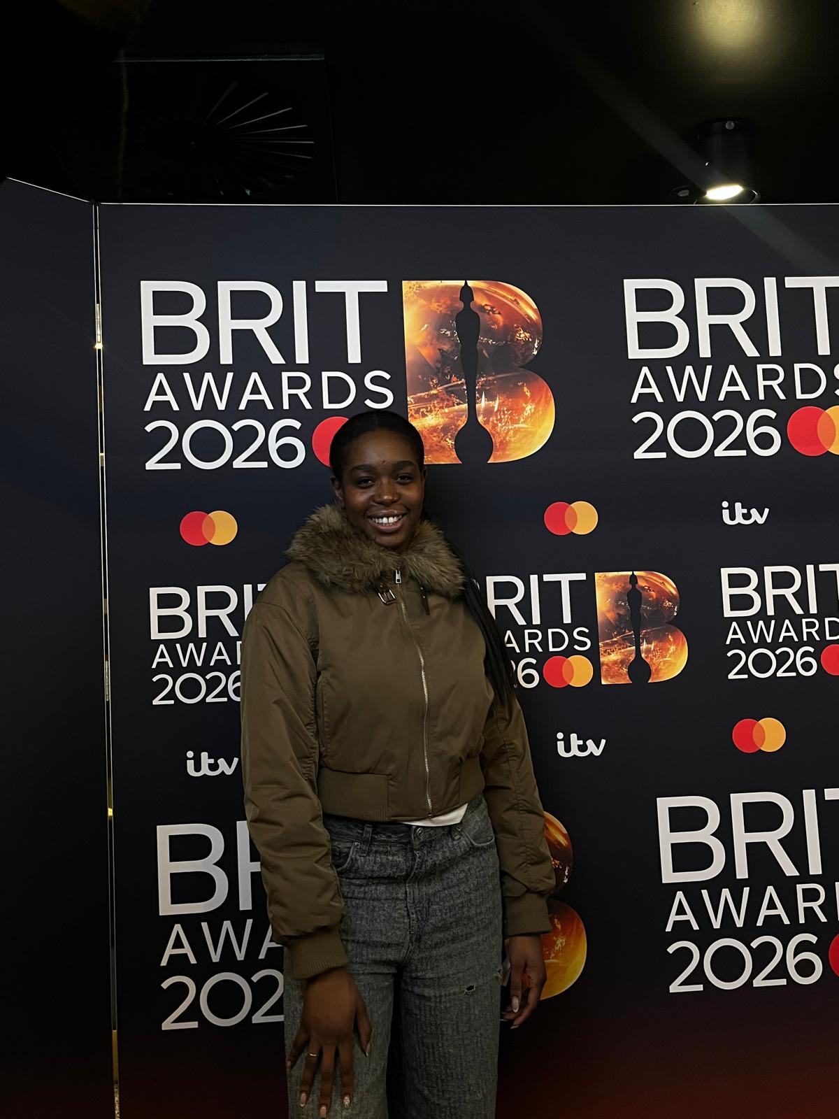 Adele Tondu stood in front of a BRITs 2026 media backdrop.