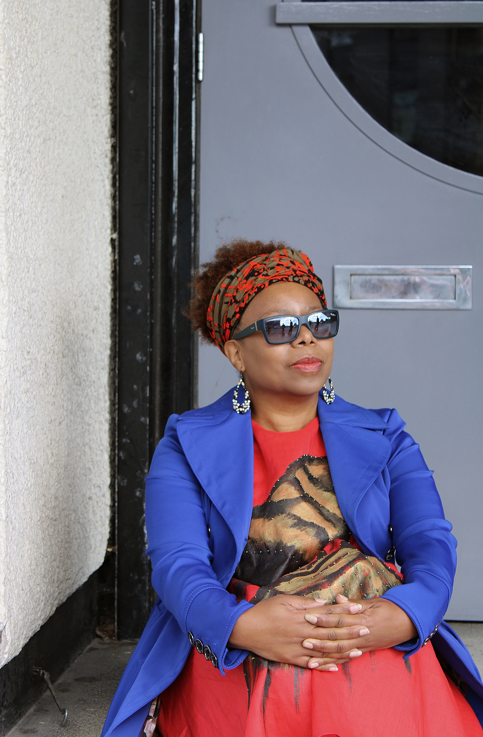 Karen Gabay sat on a stair in front of a door.