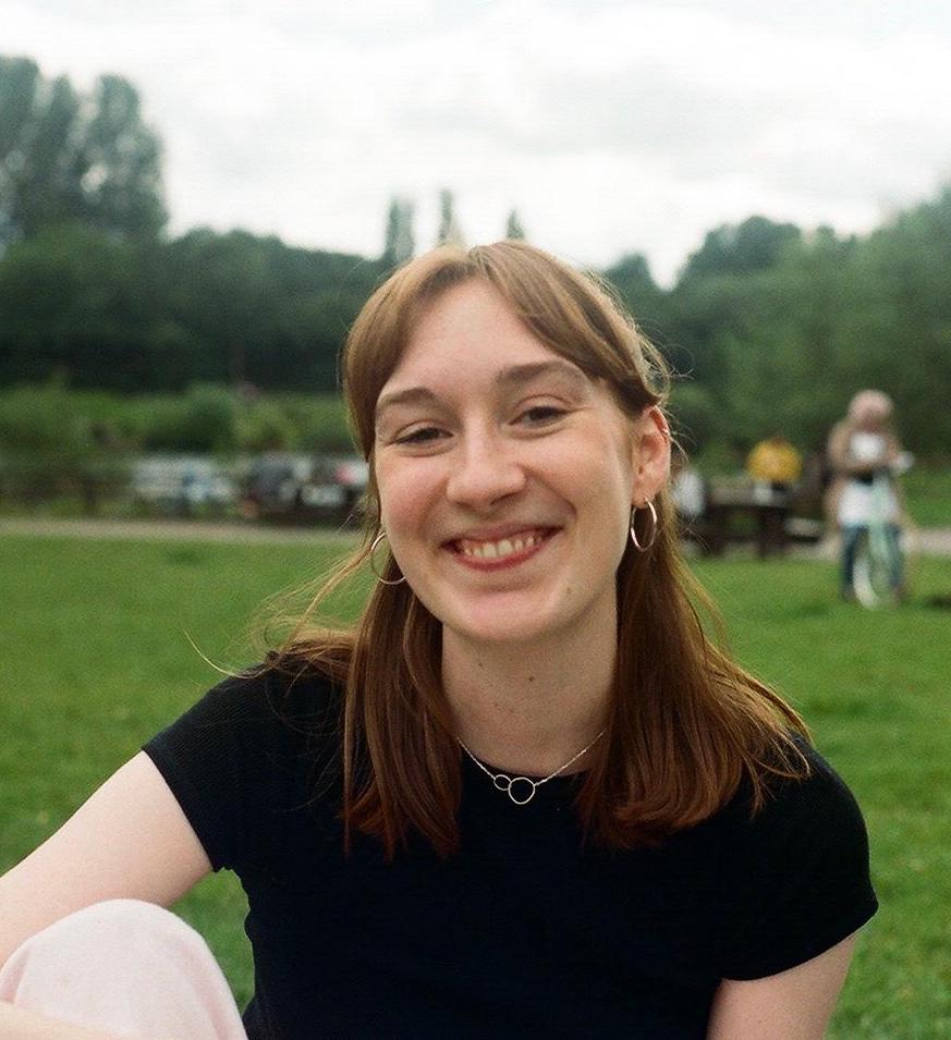 Olivia Swift smiling to camera in a park.