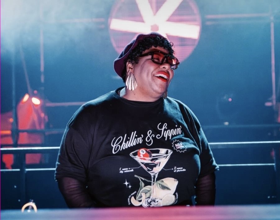 Rebecca Swarray smiling in a nightclub.