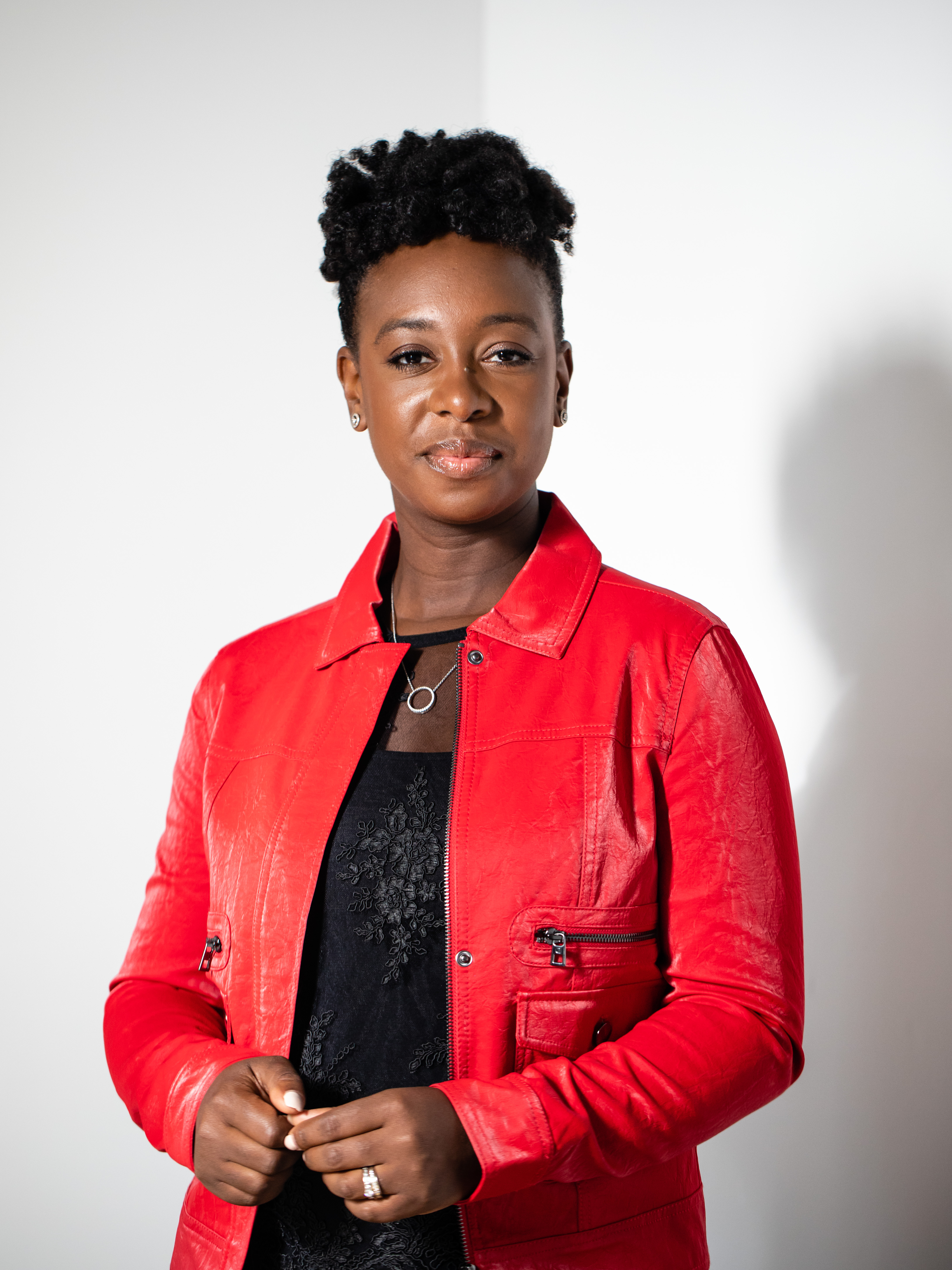 YolanDa Brown looking to camera against a white wall.