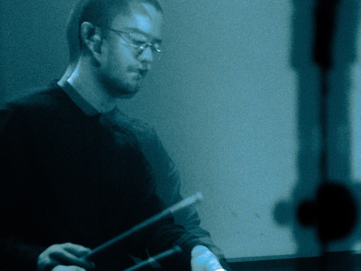 A blurred image of a drummer.