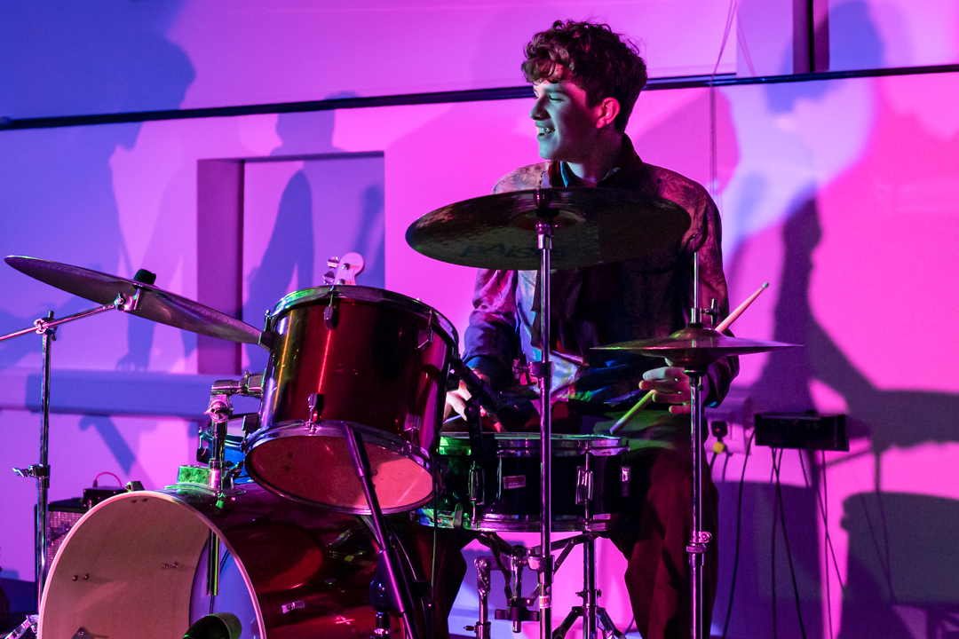 A young musician playing drums.