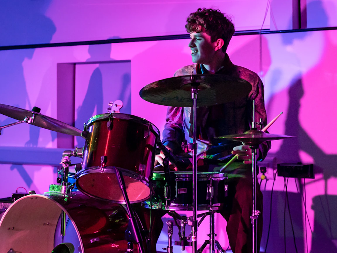 A young musician playing drums.