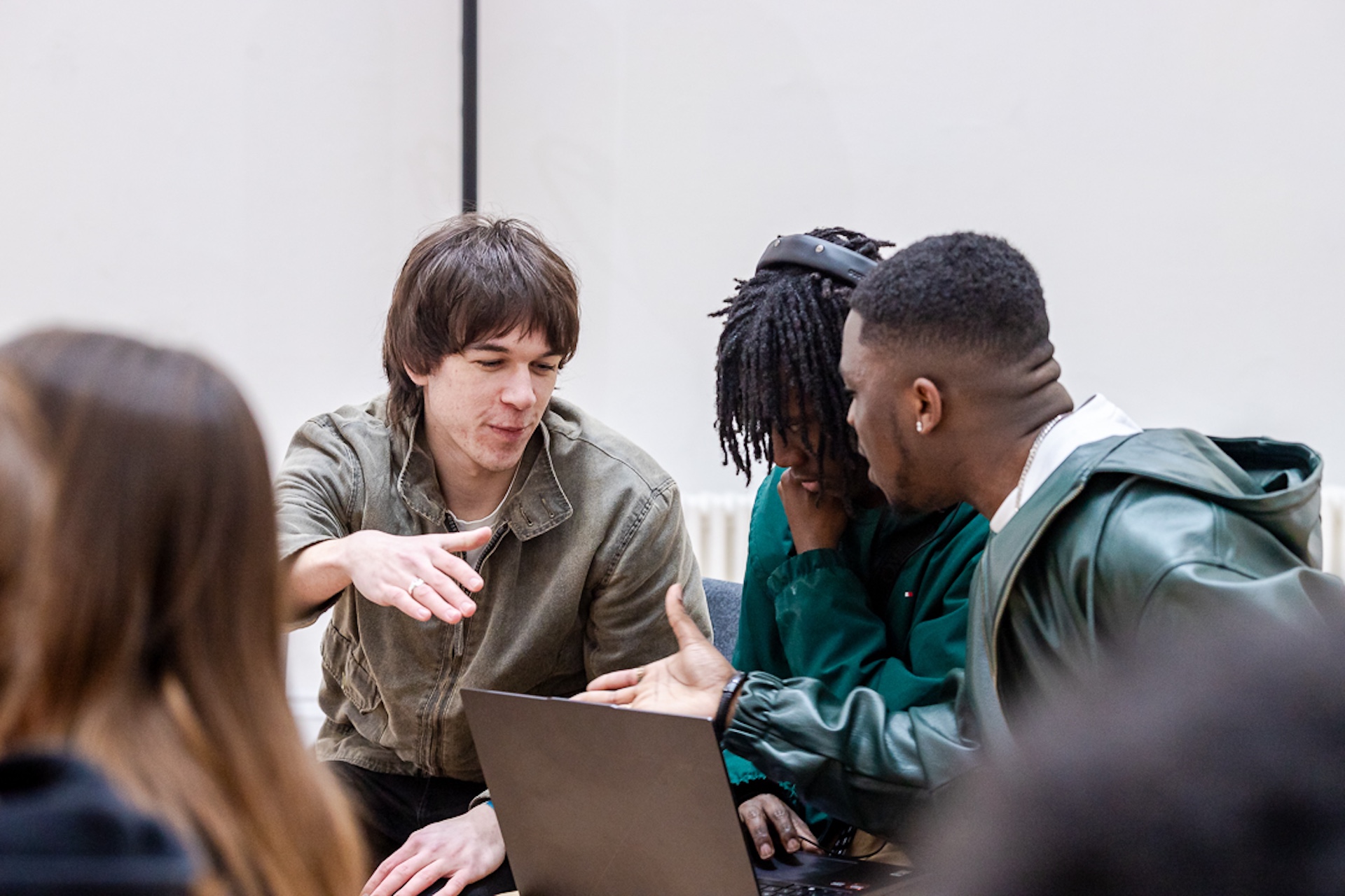 Young musicians shaking hands at a networking event.