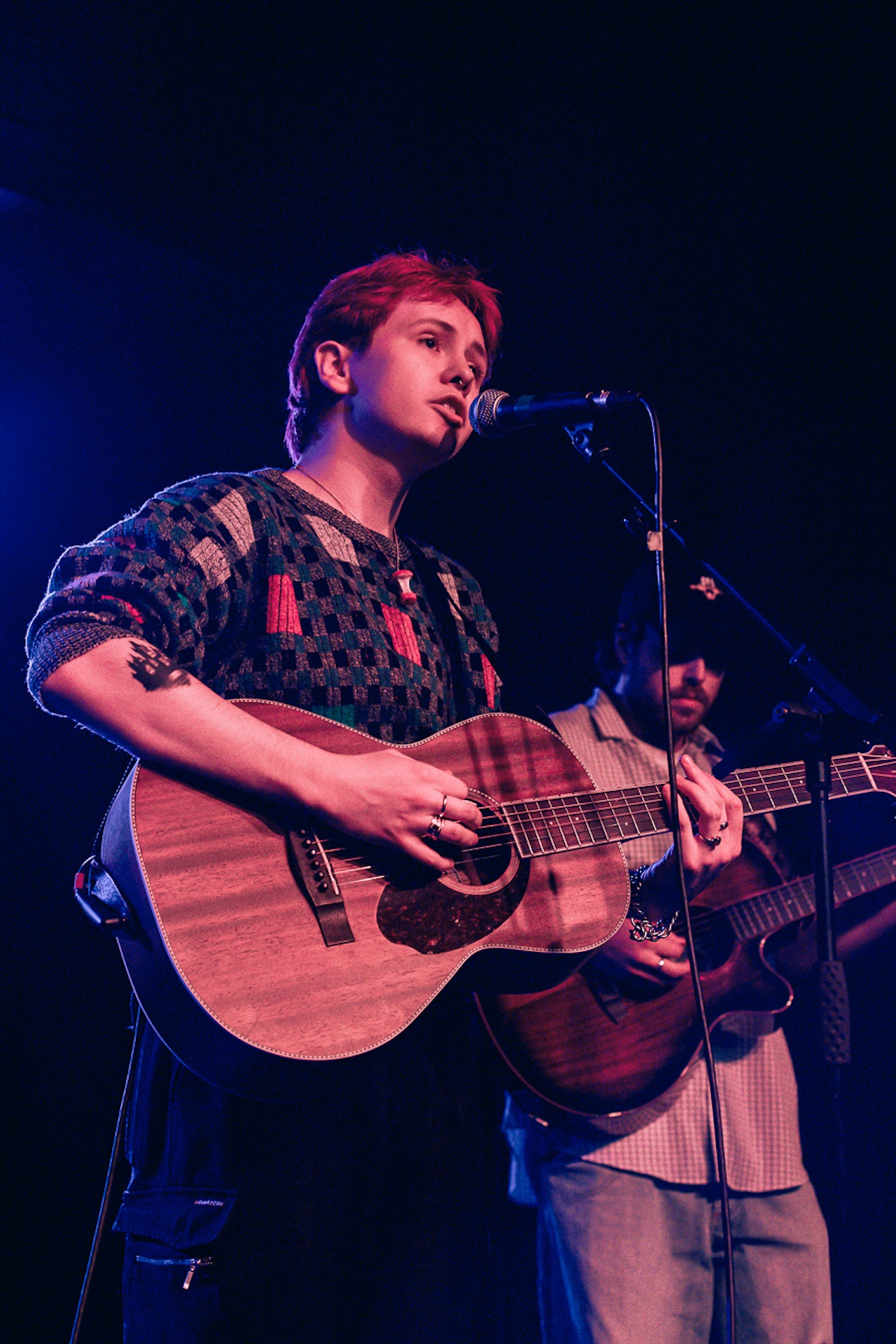 Musician with a guitar and a mic.