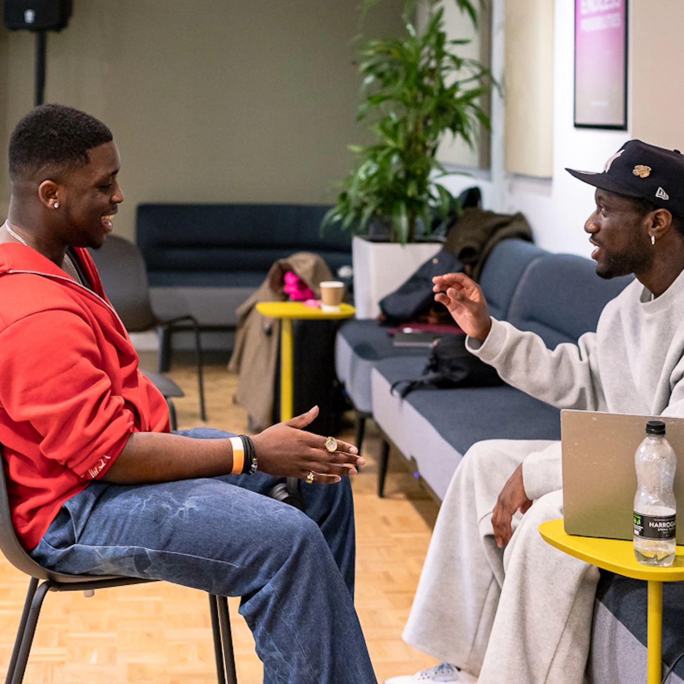 A young musician sat chatting with an industry professional.