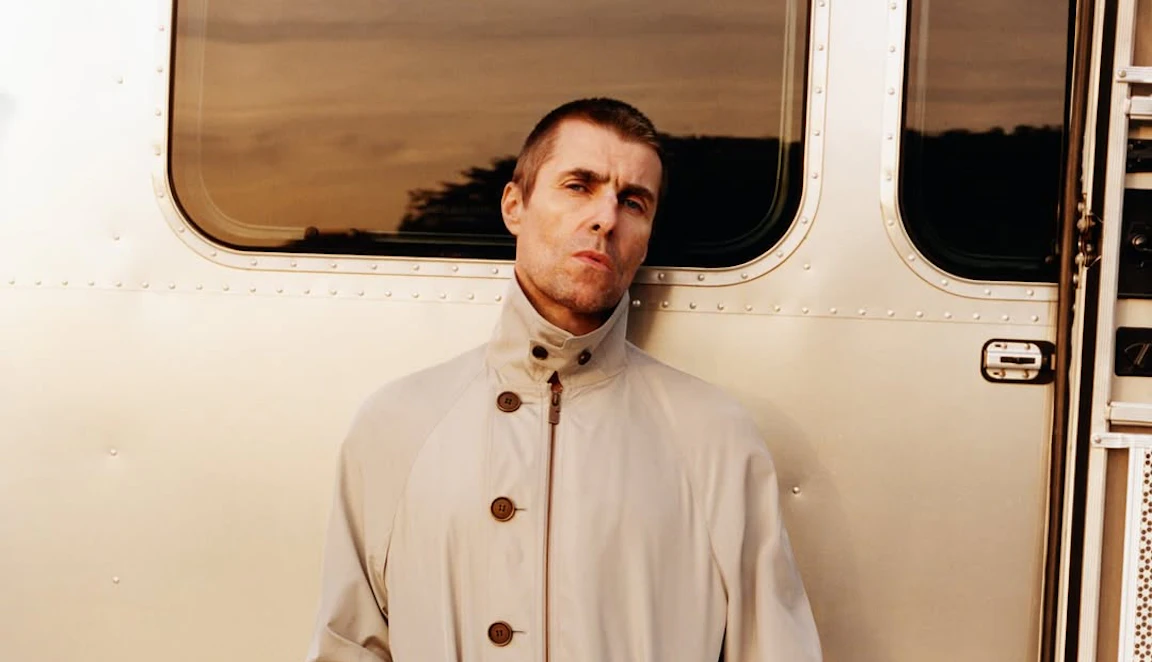Photo of Liam Gallagher wearing a cream coloured Burberry mac