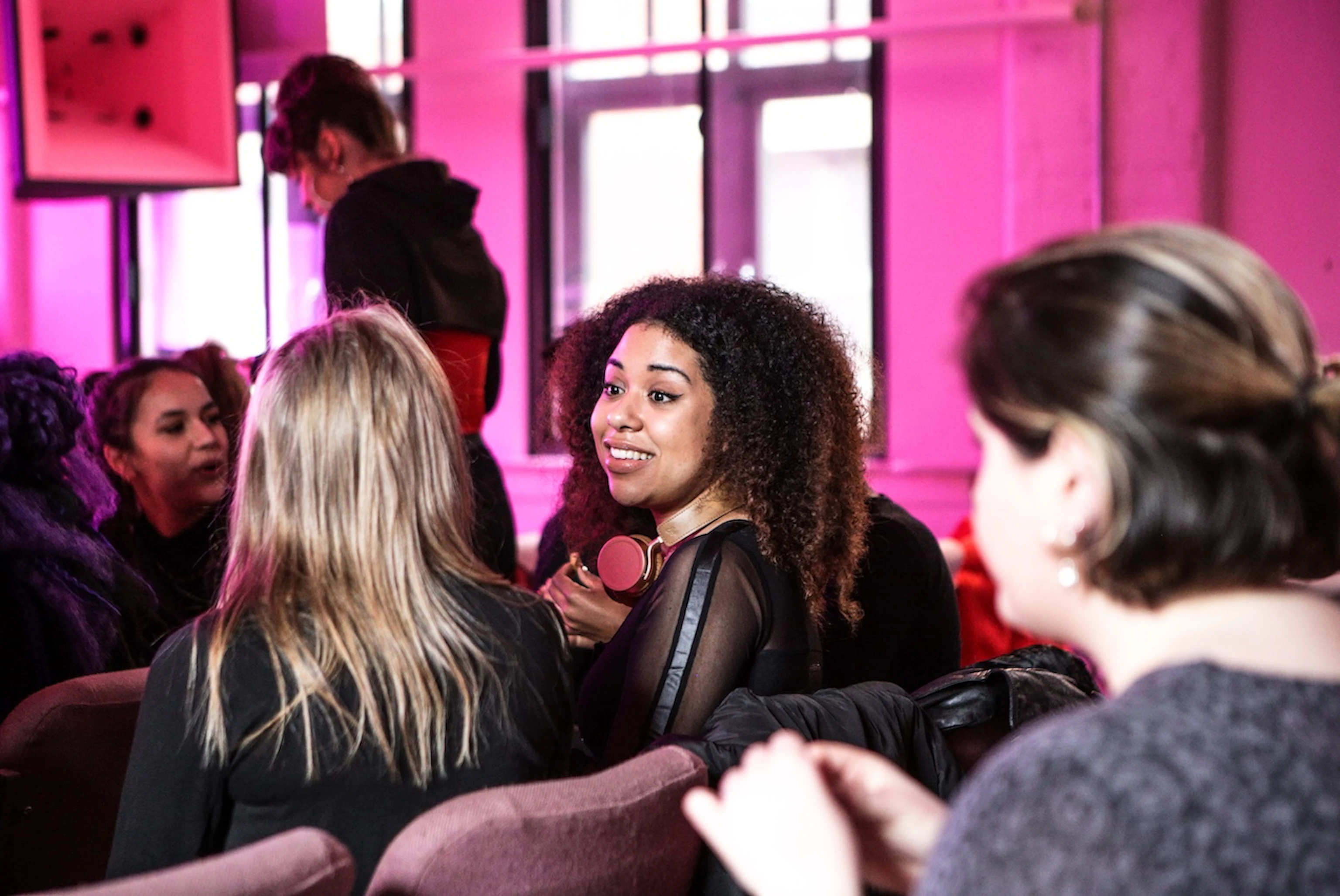 People networking in the Pink Room at YES