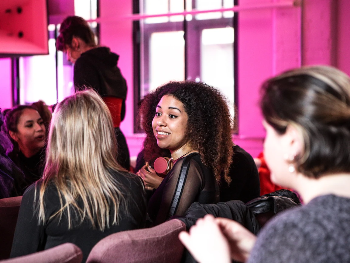 People networking in the Pink Room at YES