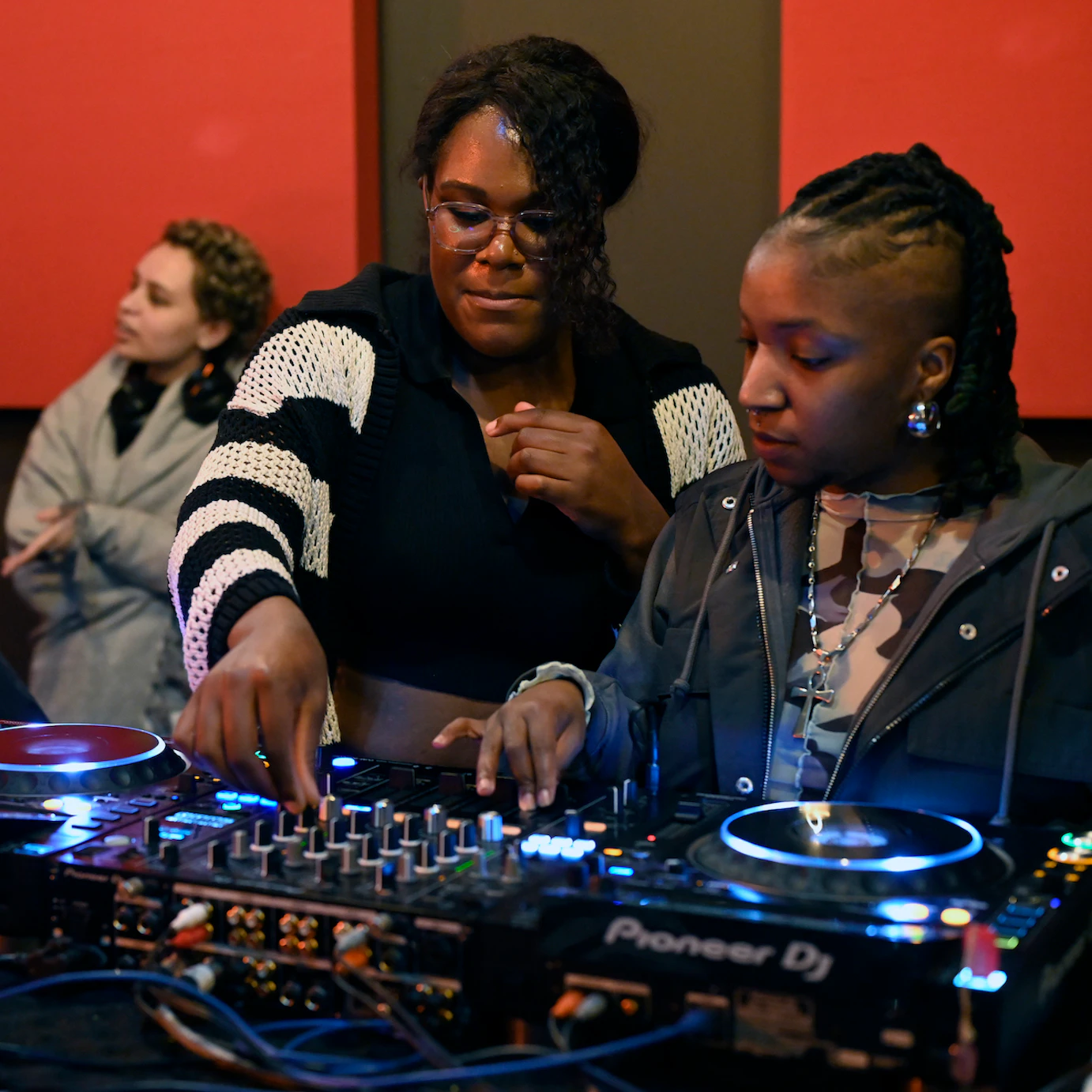 Guest artists Ifeoluwa and residency artists exploring sounds on DJ decks.