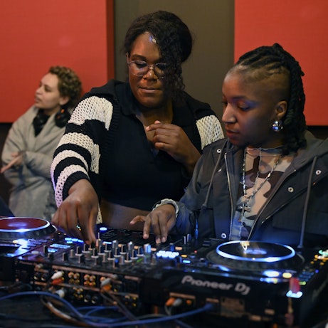 Guest artists Ifeoluwa and residency artists exploring sounds on DJ decks.