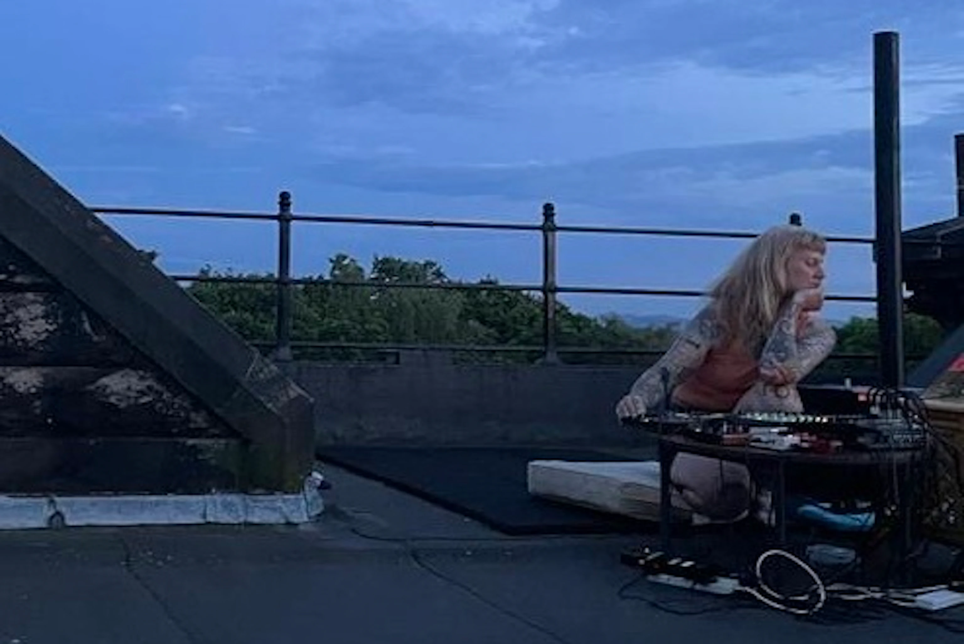 Quieting on a rooftop knelt by a mixing desk