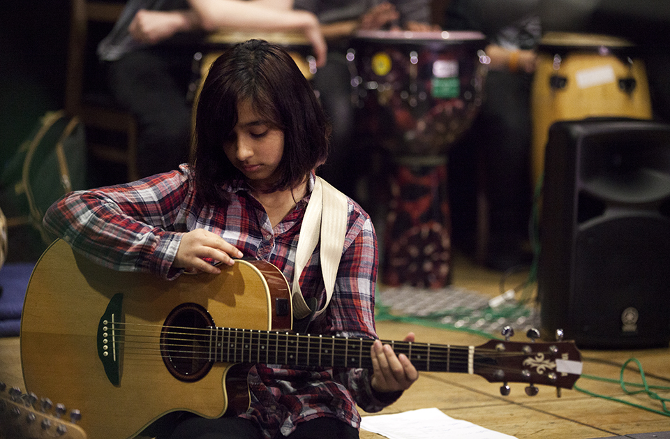 A musician holding a guitar.