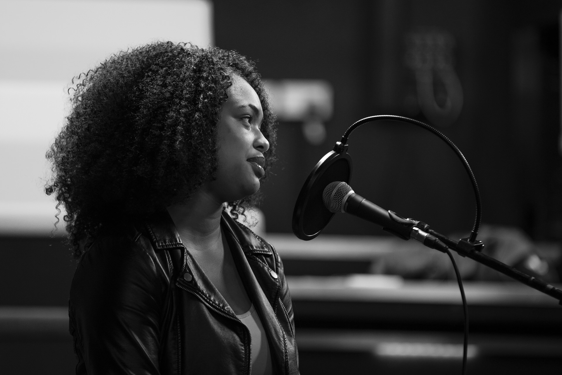 A participant sat by a microphone looking off to the right.