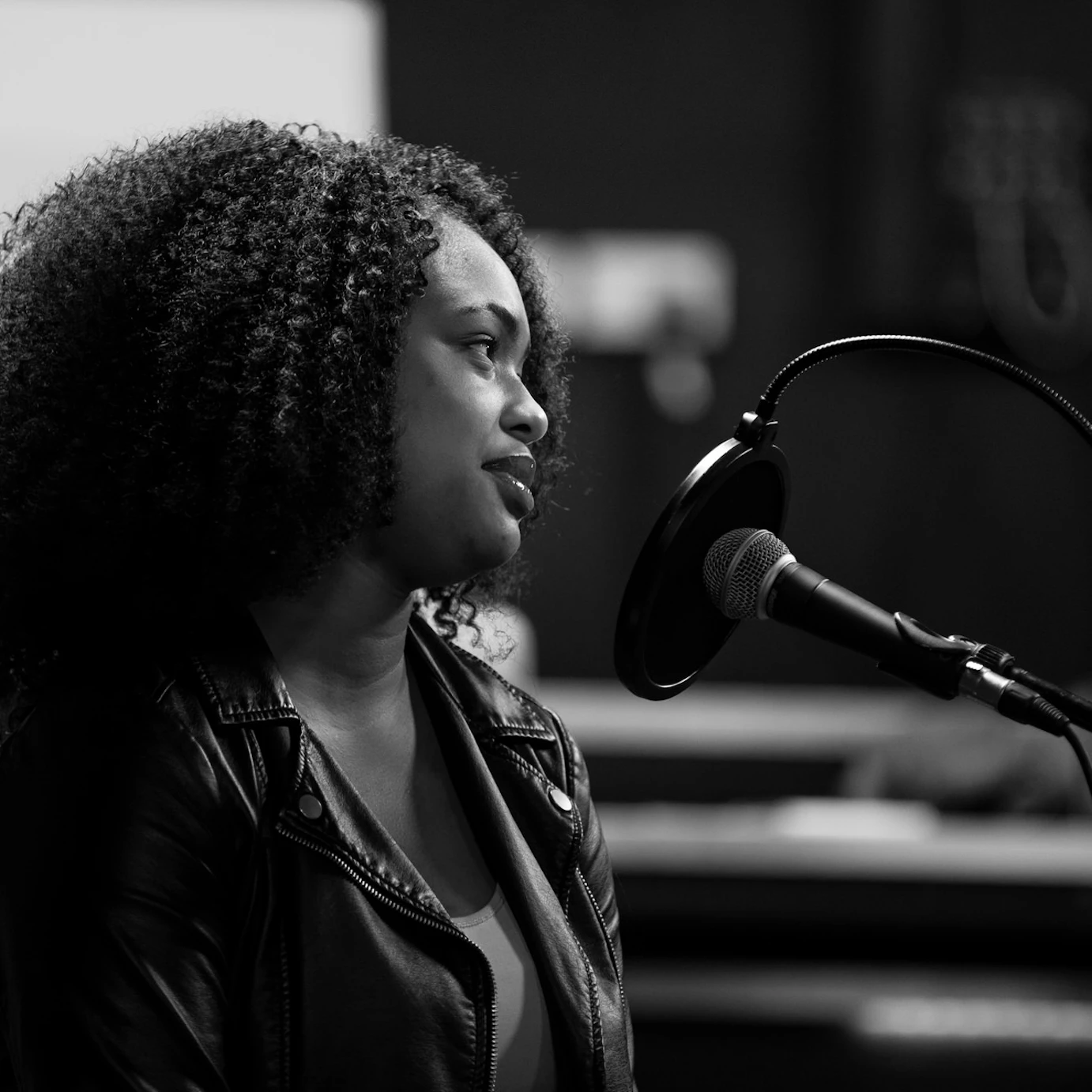 A participant sat by a microphone looking off to the right.