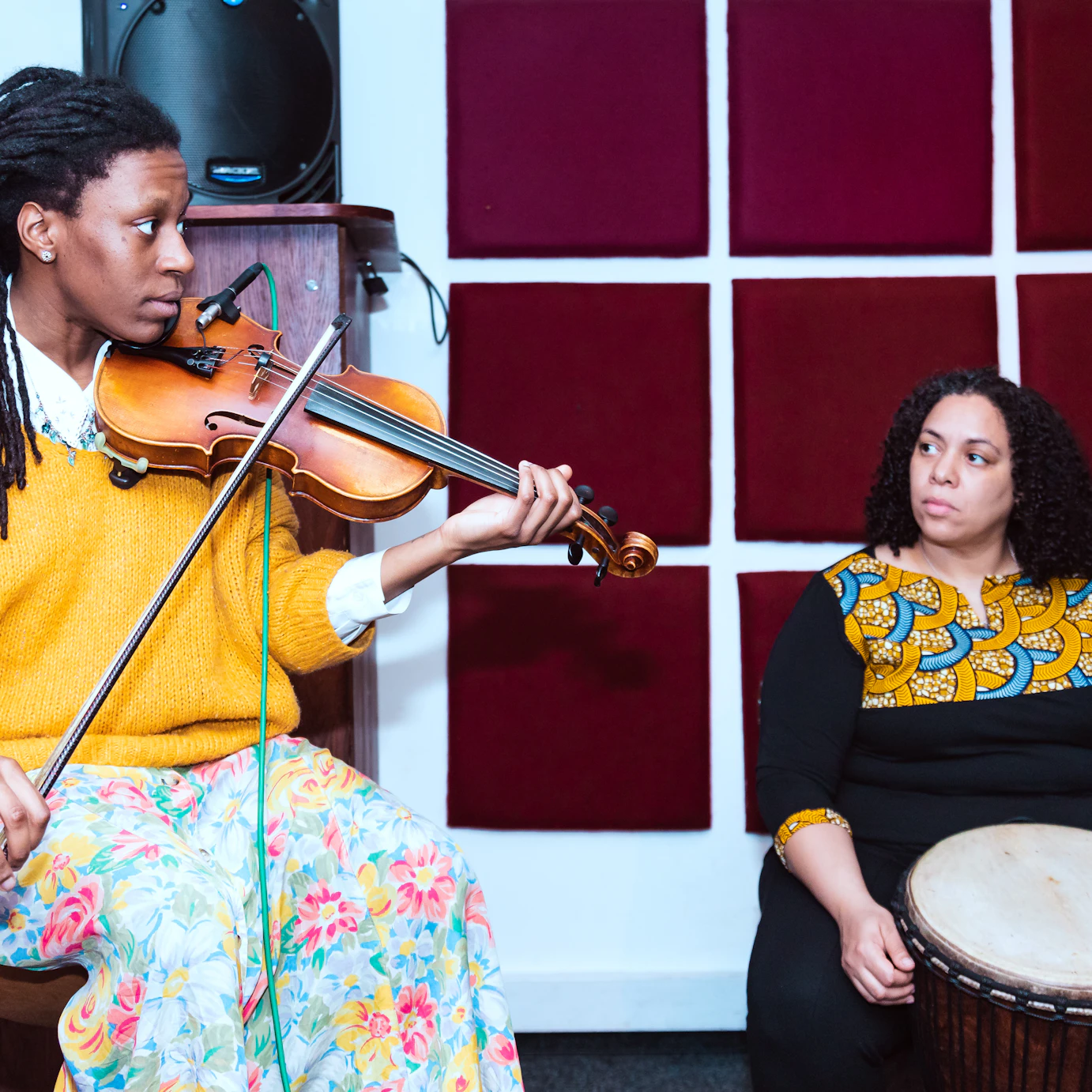 Sam Brown and Yilis del Carmen Suriel in the studio playing violin and Djembe respectively.