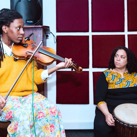 Sam Brown and Yilis del Carmen Suriel in the studio playing violin and Djembe respectively.