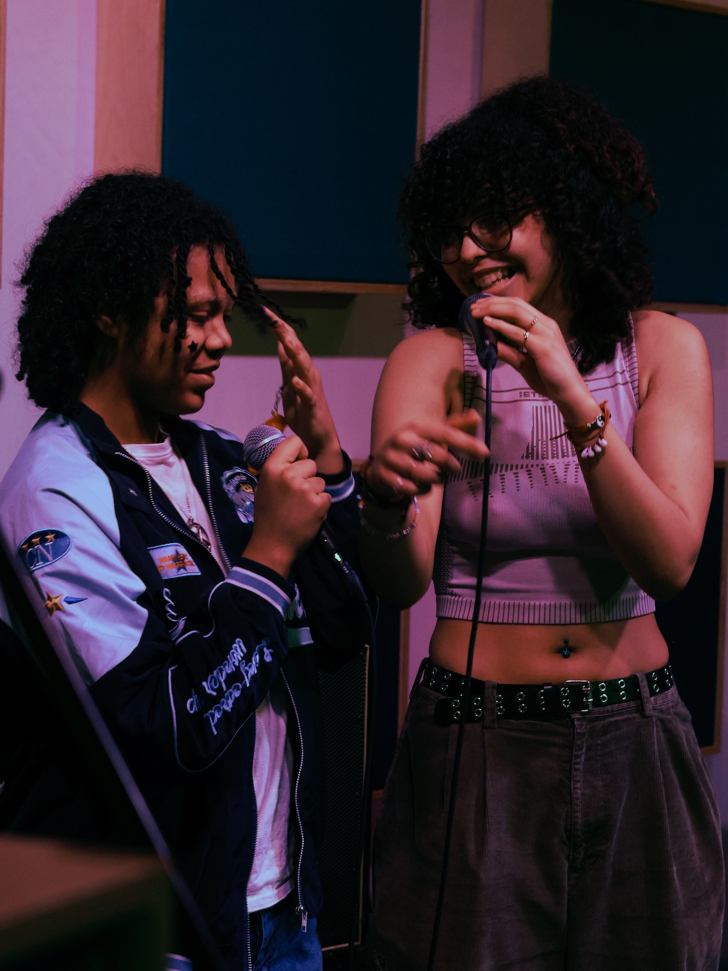 Two musicians with microphones smiling.