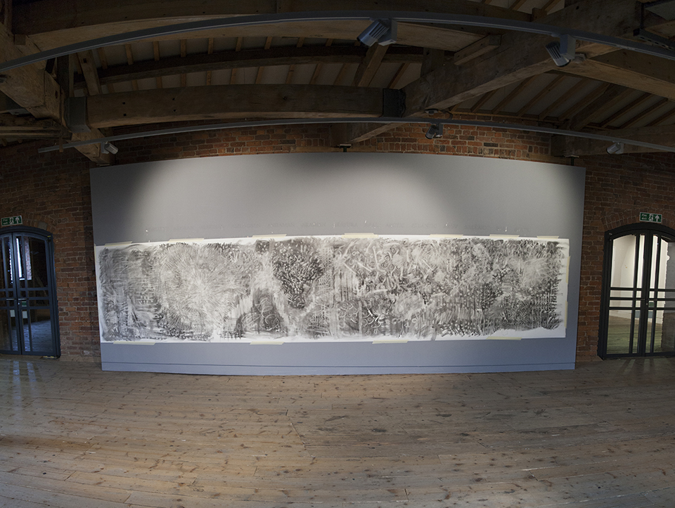 A charcoal artwork on a wall.