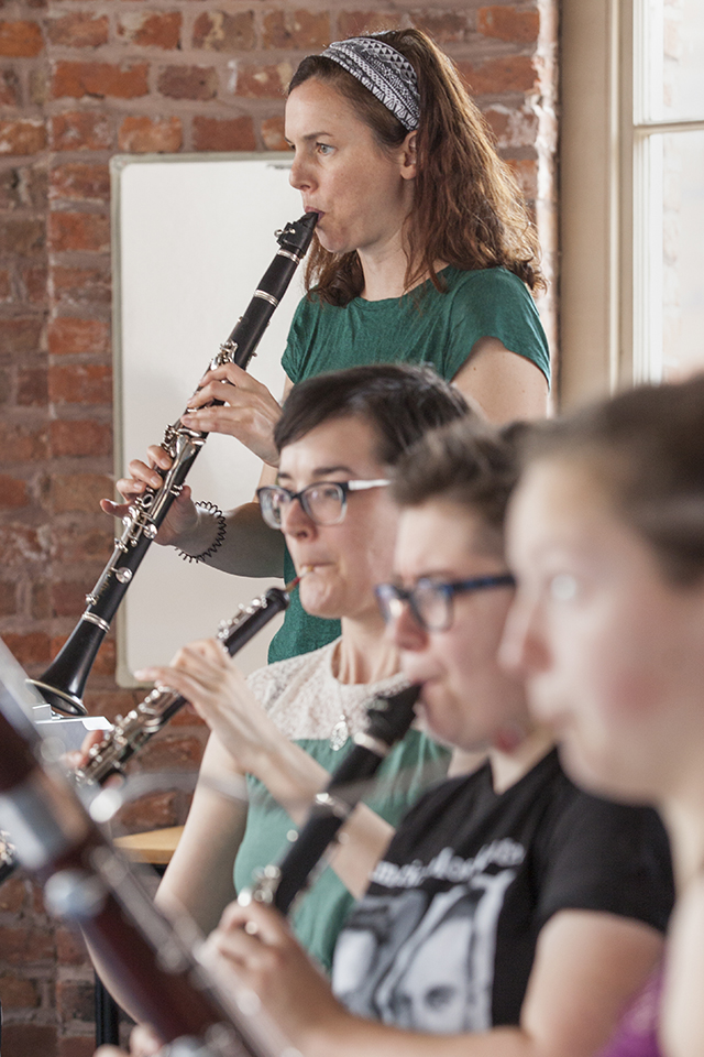 Anna Meredith playing flute alongside other musicians.