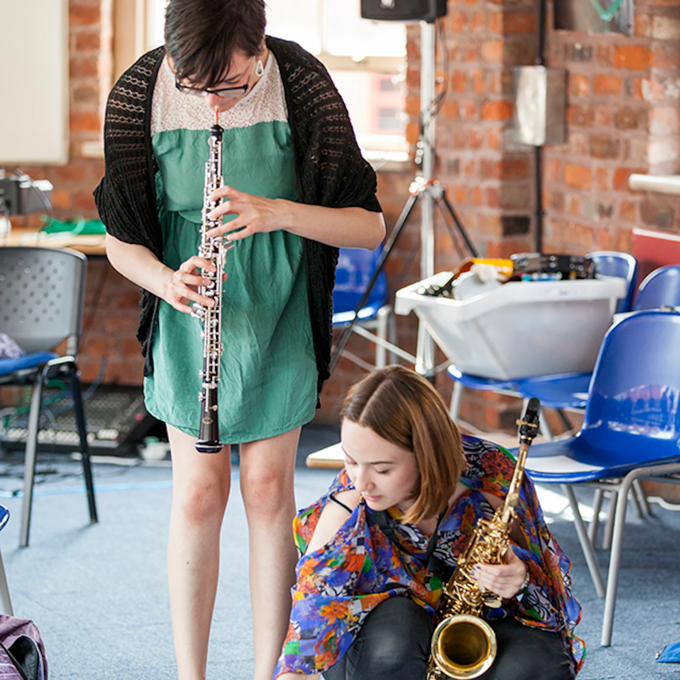 A clarinetist and a saxophonist collaborating.