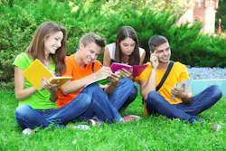 students sitting on grass
