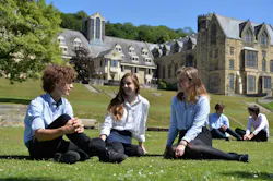 Ampleforth students sitting on grass