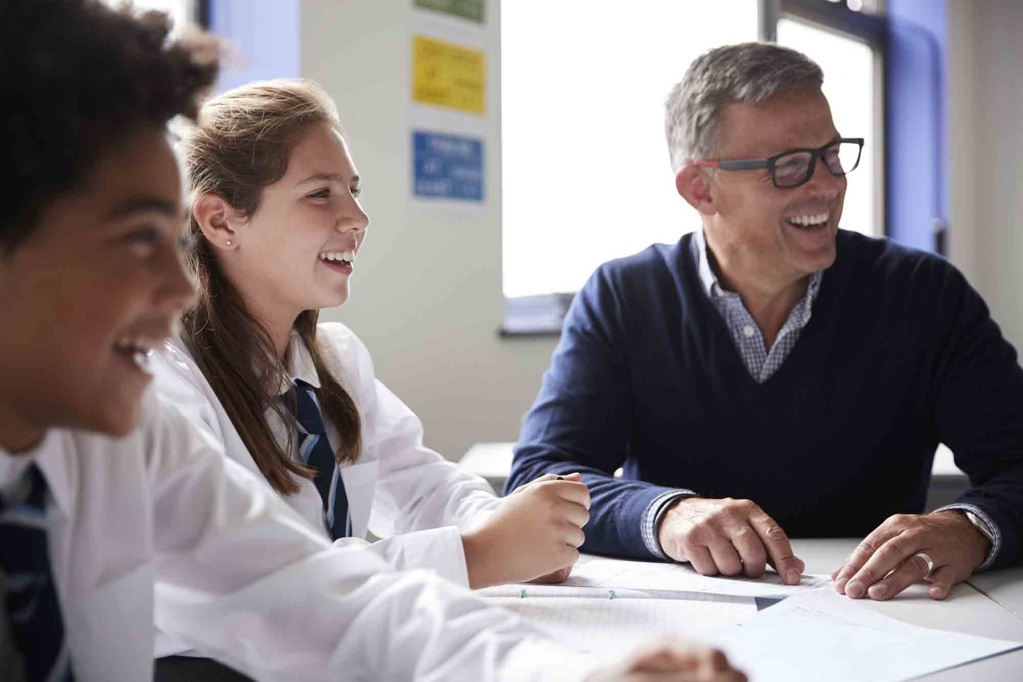 Students Laughing With a Teacher