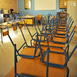 chairs upturned in classroom