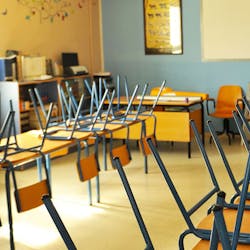 chairs upturned in classroom