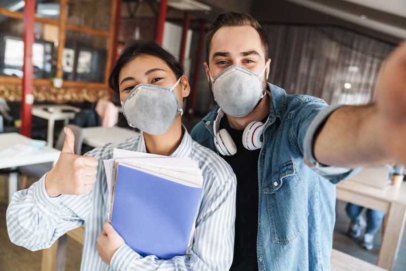 happy students in masks 