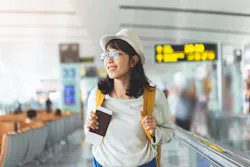 girl at airport with passport 