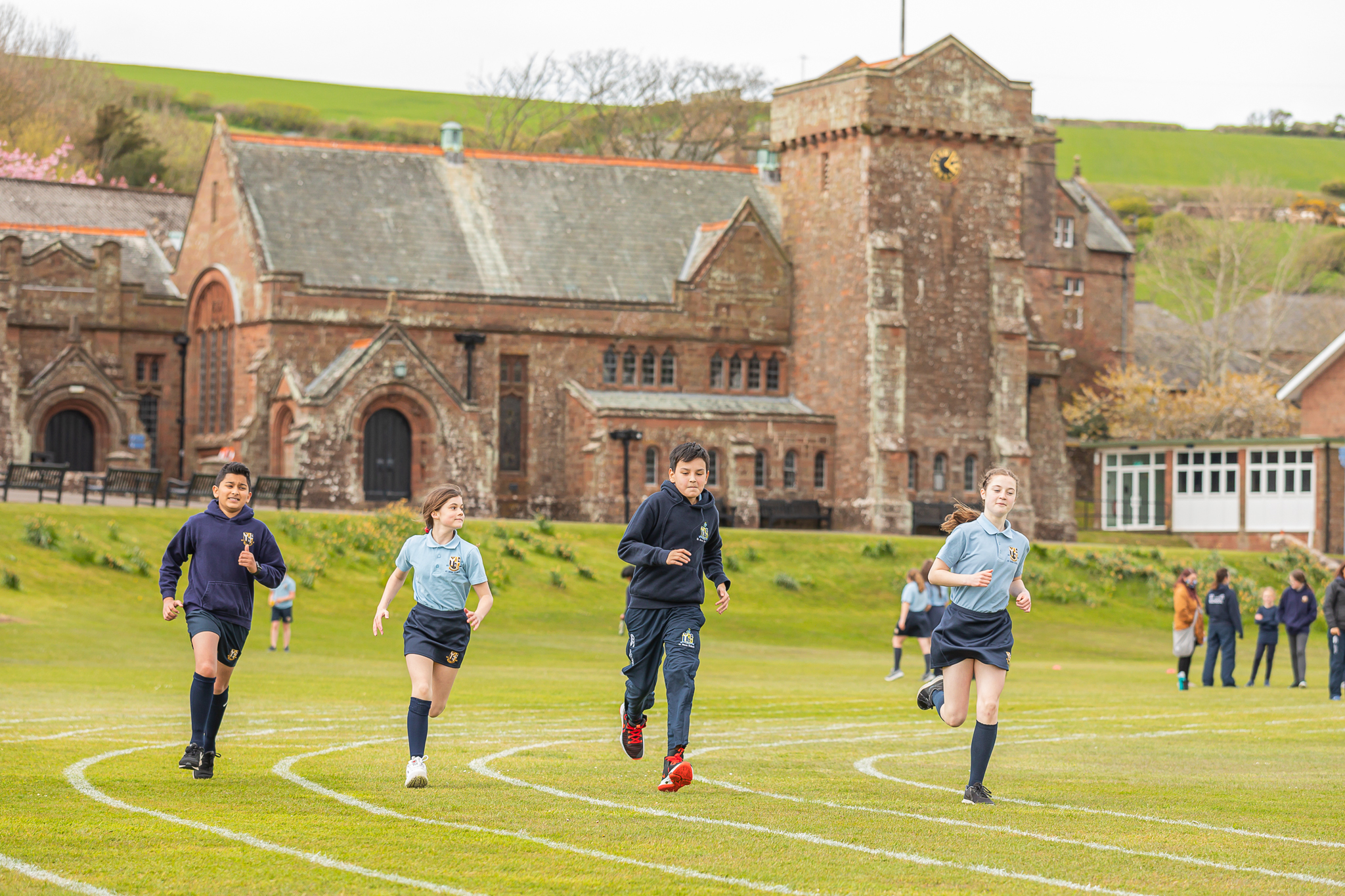 children running on grass track