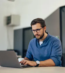 Man on computer looking intently