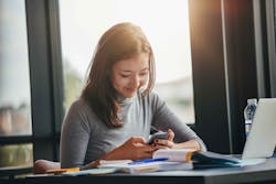 Girl on phone at desk