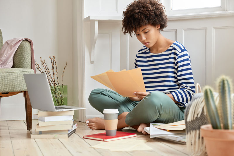 girl sitting on floor studying