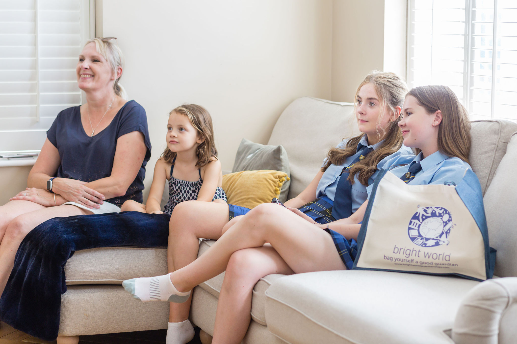 girls watching tv on sofa