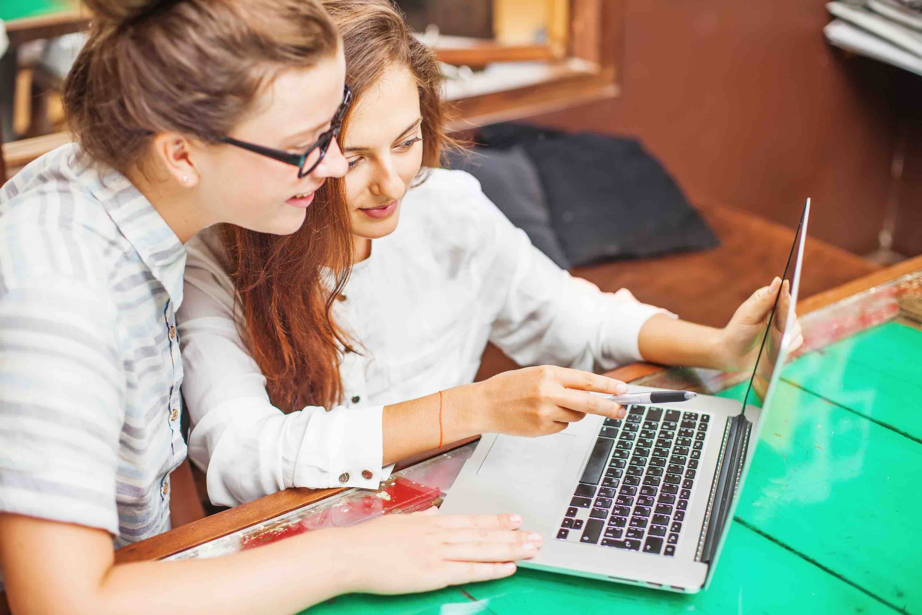 Students looking at laptop