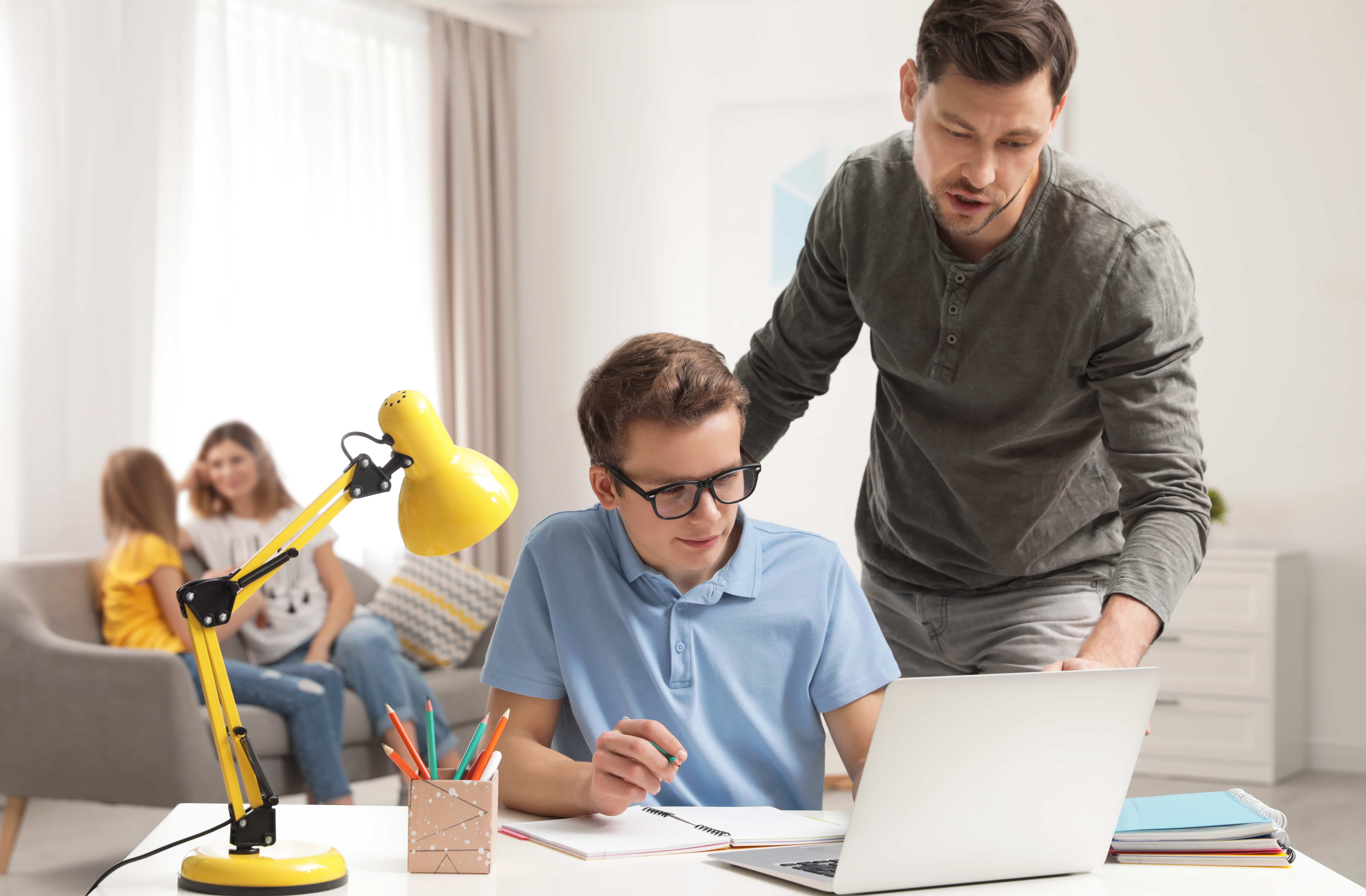 boy at computer with father 
