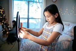 child filming a video